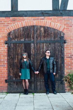 happy guy and girl walking along the tourist streets of old Europe in the city of Gdanskの写真素材