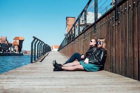 happy guy and girl walking along the tourist streets of old Europe in the city of Gdansk