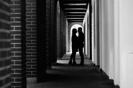 happy guy and girl walking along the tourist streets of old Europe in the city of Gdanskの写真素材