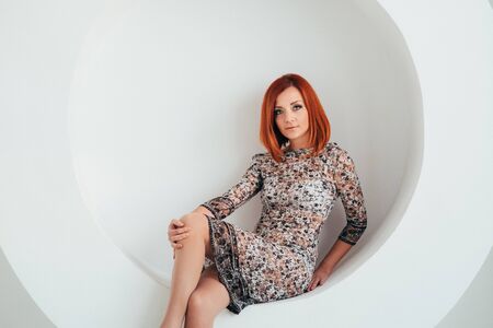 red-haired model girl with blue eyes on a white circle backgroundの写真素材
