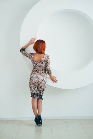 red-haired model girl with blue eyes on a white circle backgroundの写真素材