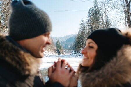 boy and girl outdoors on a winter walk playing snowballs and sleddingの写真素材