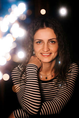 girl lit sparklers inside a wooden house late at nightの写真素材
