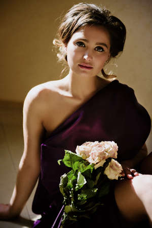 model girl in a blue dress in an art workshop with brushes, a palette and paintingsの写真素材