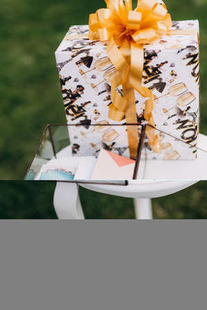 glass box with wedding gifts in envelopes on the tableの写真素材