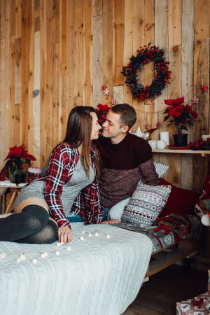 a guy and a girl celebrate the new year together in a warm atmosphere and give each other giftsの写真素材