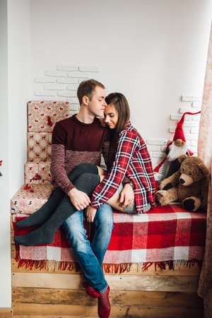 a guy and a girl celebrate the new year together in a warm atmosphere and give each other giftsの写真素材