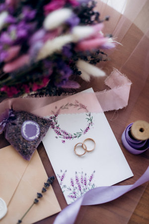 wedding rings with wedding decor of dried flowersの写真素材