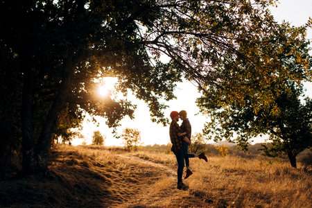 Cheerful guy and girl on a walk in bright knitted hats and plaid shirtsの写真素材