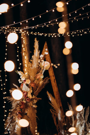 wedding ceremony area with dried flowers in a meadow in a pine brown forestの写真素材