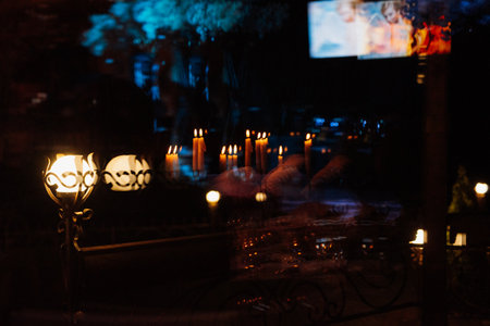 decoration of tables with burning candles, decor in shades of black, red and whiteの写真素材