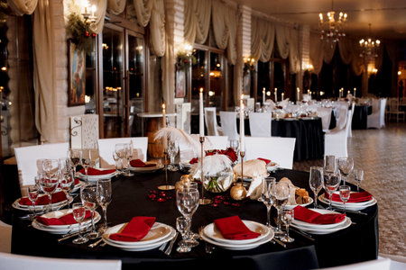 decoration of tables with burning candles, decor in shades of black, red and whiteの写真素材