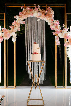white wedding cake at the wedding of the newlywedsの写真素材