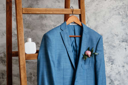 blue blazer classic suit hanging on a wooden ladderの写真素材