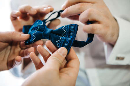 the bride and groom tenderly hold hands between them love and relationshipsの写真素材