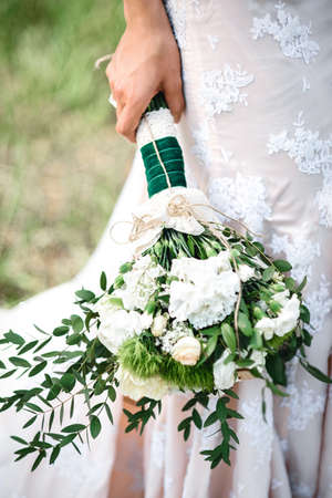 elegant wedding bouquet of fresh natural flowers and greeneryの写真素材
