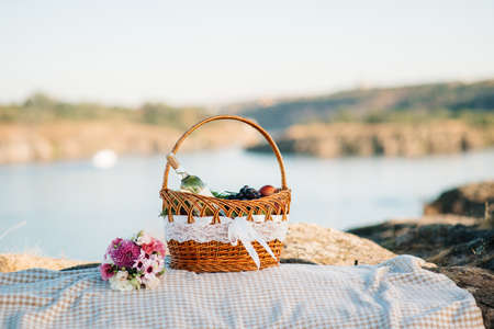 picnic in nature with a basket of delicious productsの写真素材