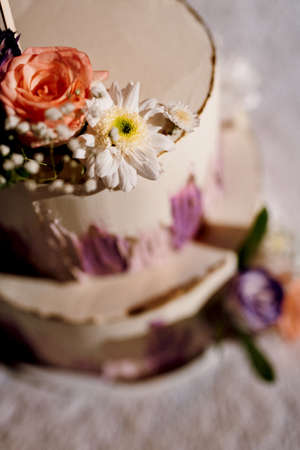 wedding decor with cake on a wooden bench against a waterfall background