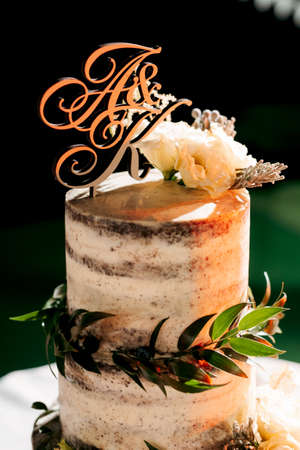 wedding decor with cake on a wooden bench against a waterfall backgroundの写真素材