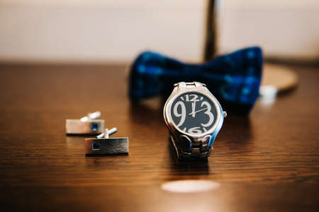 wedding ring in a box and watch the groom on the tableの写真素材