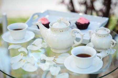 Tea drinking black tea with porcelain cups and a teapotの写真素材