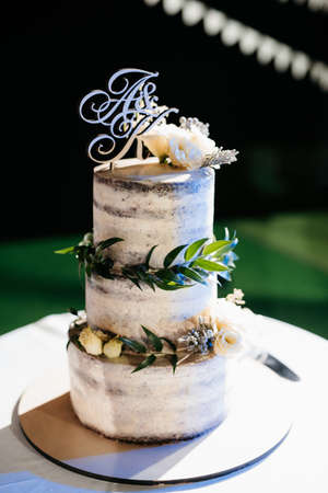 wedding decor with cake on a wooden bench against a waterfall background