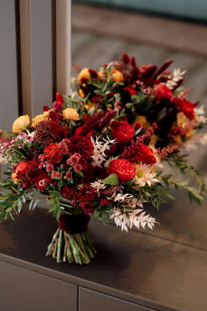 red elegant wedding bouquet of fresh natural flowers and greeneryの写真素材