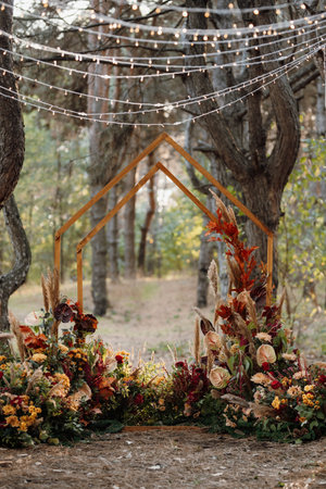 wedding ceremony area with dried flowers in a meadow in a pine brown forestの写真素材