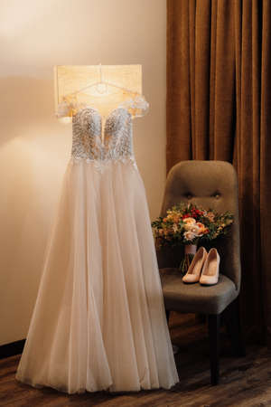 perfect white wedding dress bridal bouquet with red autumn shades of Kenyan dried flowersの写真素材