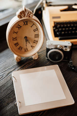 book of wishes made of wood next to the clock a camera with snapshotsの写真素材