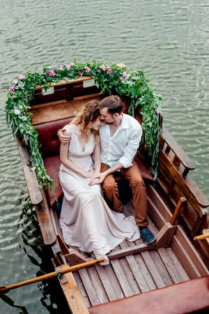 a boat trip for a guy and a girl along the canals and bays of the river overgrown with wild willowsの写真素材