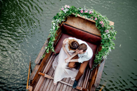 a boat trip for a guy and a girl along the canals and bays of the river overgrown with wild willowsの写真素材