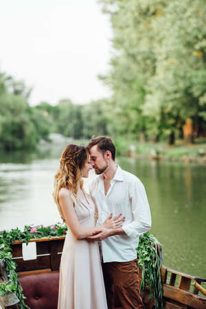 a boat trip for a guy and a girl along the canals and bays of the river overgrown with wild willowsの写真素材