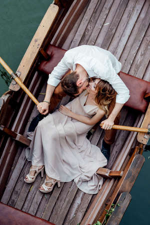 a boat trip for a guy and a girl along the canals and bays of the river overgrown with wild willowsの写真素材