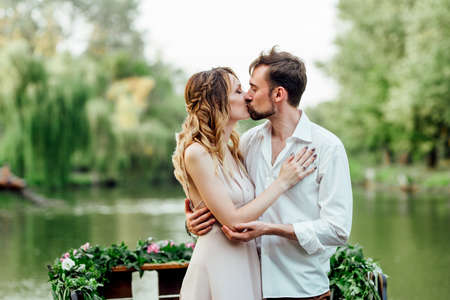 a boat trip for a guy and a girl along the canals and bays of the river overgrown with wild willowsの写真素材