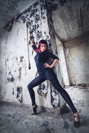 girl model in black with pink hair in an abandoned buildingの写真素材
