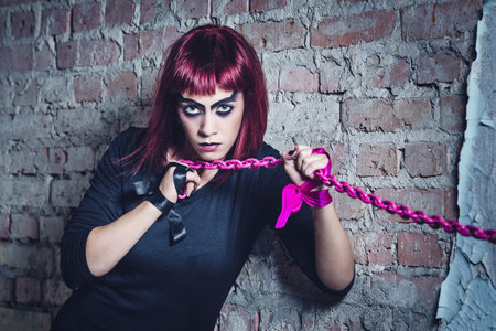 girl model in black with pink hair in an abandoned buildingの写真素材