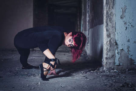 girl model in black with pink hair in an abandoned buildingの写真素材