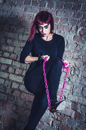 girl model in black with pink hair in an abandoned buildingの写真素材