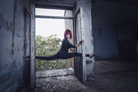 girl model in black with pink hair in an abandoned buildingの写真素材