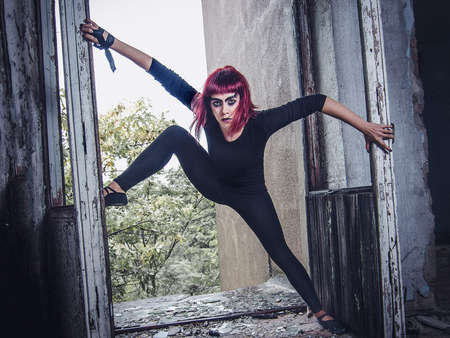 girl model in black with pink hair in an abandoned buildingの写真素材