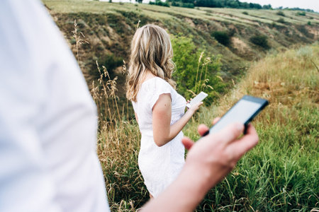 a guy with a girl in light clothes on the background of a green canyon of erosion of the earthの写真素材