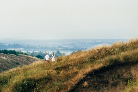 a guy with a girl in light clothes on the background of a green canyon of erosion of the earthの写真素材