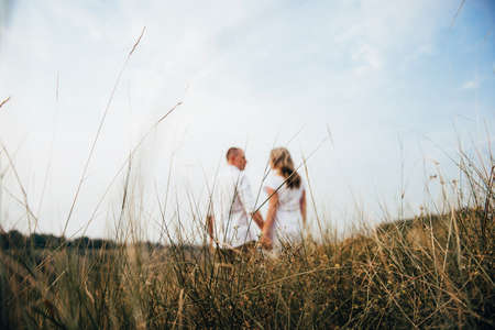 a guy with a girl in light clothes on the background of a green canyon of erosion of the earthの写真素材