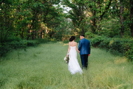 A couple in love a guy and a girl on a walk in the forest beltの写真素材