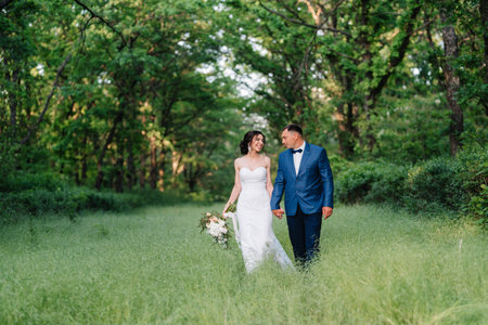 A couple in love a guy and a girl on a walk in the forest beltの写真素材