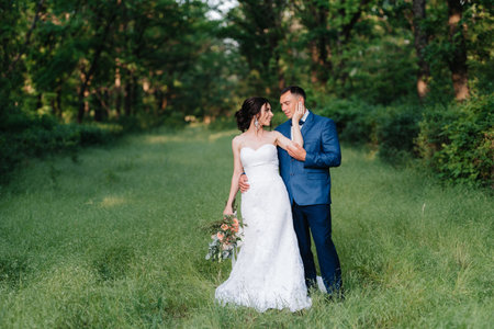 A couple in love a guy and a girl on a walk in the forest beltの写真素材