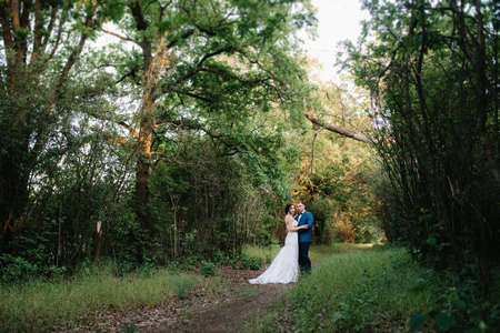 A couple in love a guy and a girl on a walk in the forest beltの写真素材