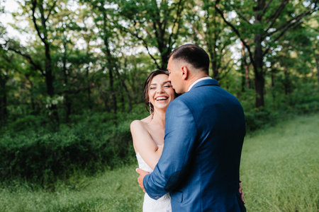A couple in love a guy and a girl on a walk in the forest beltの写真素材
