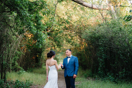 A couple in love a guy and a girl on a walk in the forest beltの写真素材